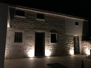 an old stone building with lights in the dark at Borgo delle Stelle in Scicli