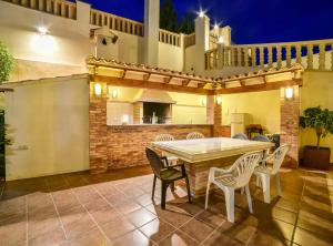 an outdoor patio with a table and chairs at Villa Alhambra - Plusholidays in Calpe