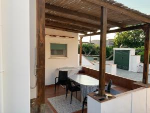 patio con mesa y sillas en el balcón en Il Merlo, en Anacapri