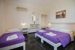 A bed or beds in a room at Skala Sunset Hotel and spa