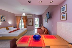 a bedroom with a bed and a table and a couch at Ktima Anastasia Green Stay Nafplio in Nafplio
