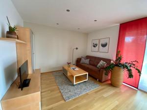 a living room with a couch and a table at Ferienwohnungen Christine in Dornbirn
