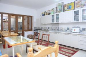 a kitchen with a table and chairs in a room at Rumi Hotel & Hostel in Bukhara