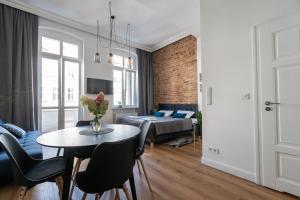 a living room with a table and a bedroom at Kamienica1899 in Szczecin
