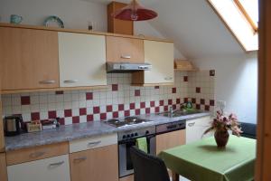 a kitchen with a table with a vase of flowers at Ferienwohnung Zauner in Hallstatt