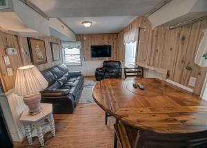 a living room with a table and a couch at Outer Banks Motel - Village Accommodations in Buxton