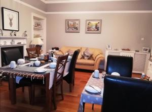 a living room with a table and a couch at Urrard B&B in Dingwall