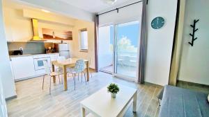 a living room with a table and a kitchen at Apartment PASMAN - appartement 50 m2 et piscine in Pakoštane