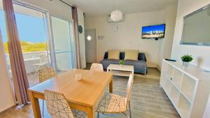 a living room with a table and a couch at Apartment PASMAN - appartement 50 m2 et piscine in Pakoštane