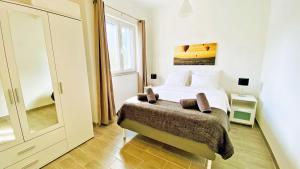 a bedroom with a bed and a large window at Apartment PASMAN - appartement 50 m2 et piscine in Pakoštane +16 photos