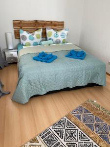 a bedroom with a large bed with blue sheets and pillows at Ferienhaus-Aladdin in Garmisch-Partenkirchen