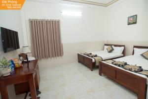 Postel nebo postele na pokoji v ubytování Magnolia Hotel Cam Ranh