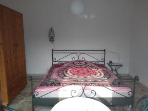 a bedroom with a bed with a wrought iron frame at Casa Lago Azzurro Apartement in Cannobio