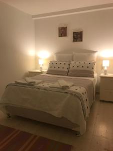 a bedroom with a large bed with two lamps on it at Smart Aparts in Kalkan