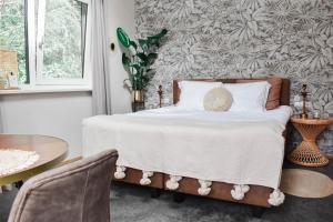 Postel nebo postele na pokoji v ubytování ForRest Suites