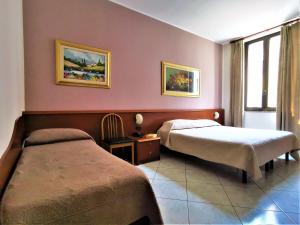 Postel nebo postele na pokoji v ubytování Hotel Venini + 37 fotografií