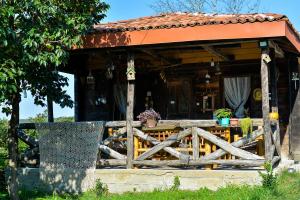a wooden house with a fence in front of it at Agro Guesthouse Korena in Kutaisi