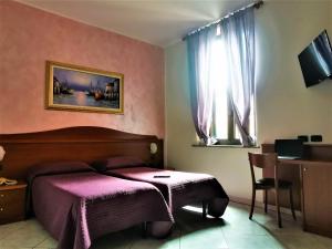 En eller flere senge i et værelse på Hotel Venini