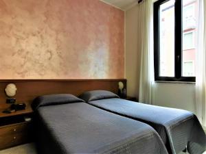 Postel nebo postele na pokoji v ubytování Hotel Venini