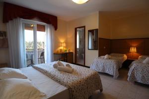 Postel nebo postele na pokoji v ubytování Hotel Righetto Fronte Mare