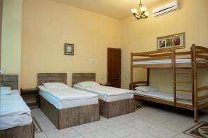 a room with three bunk beds in it at Primavera Guest House in Yerevan