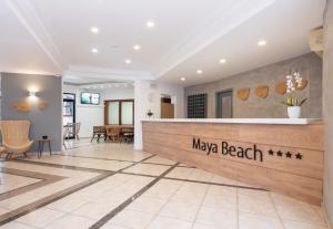 a lobby of a beach resort with a reception desk at Enorme Maya Beach Hotel-Adults Only in Gouves