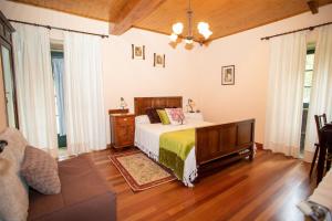 Schlafzimmer mit einem Bett und Holzboden in der Unterkunft Casa de Barreiro in Teijeiro