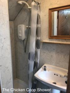 a bathroom with a sink and a shower at Barfad Self Catering Holiday Cottages in Tarbert