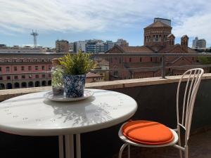 a table and chairs on a balcony with a view of a city at Milano 71 in Milan