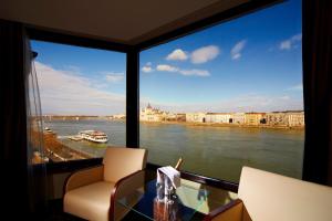 a view of a river from a room with a window at Boutique Hotel Victoria Budapest in Budapest