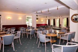 a restaurant with tables and chairs in a room at The Burlington Hotel in Torquay