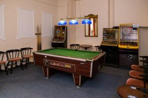 a room with a pool table and arcade machines at The Burlington Hotel in Torquay