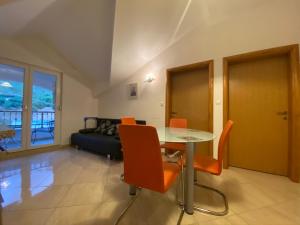 a living room with a table and chairs and a couch at Apartments Grozdana in Gradac