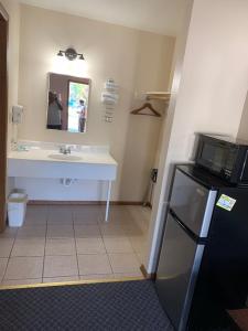 a bathroom with a sink and a refrigerator at Foster Inn Monticello in Monticello