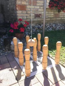 a game of chess is made out of wooden mannequins at Jarmila Vendégház in Balatonberény