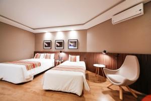 Un pat sau paturi într-o cameră la Grand Hotel Royal Sorocaba by Atlantica