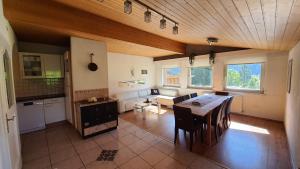 a kitchen and living room with a table and chairs at Chalet Landhaus Einsiedler in Sankt Gallenkirch