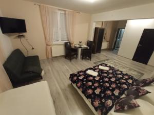 a bedroom with a bed and a table and chairs at Monato in Poprad