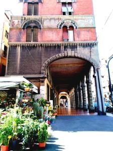 a building with an archway with plants in front of it at B&B Amarantha Gothica Genoa in Genoa