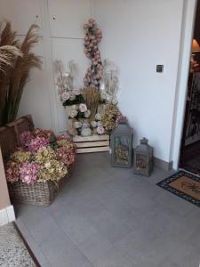a room with flowers and vases on a wall at La Corte di Rosa in San Vito al Tagliamento