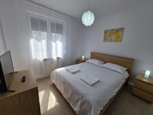 a bedroom with a bed with two towels on it at Mia Apartament in Tulcea