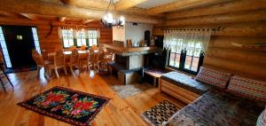 a living room with a fireplace and a dining room at Bordeiul Legionarilor in Vatra Dornei +9 photos