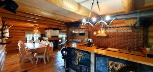 a bar in a restaurant with a table and chairs at Bordeiul Legionarilor in Vatra Dornei