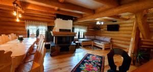 a living room with a table and a fireplace at Bordeiul Legionarilor in Vatra Dornei