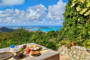 a picnic table with a plate of food on it at The Paradise Peak in Saint Martin