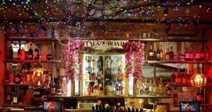 a bar with a display of bottles of alcohol at The Cherry Rooms in London