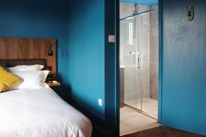 a bedroom with a bed and a glass shower at The Cherry Rooms in London