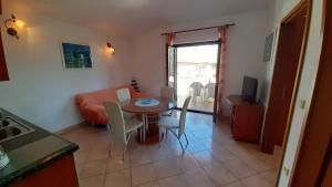 a kitchen and dining room with a table and chairs at Villa Linet Garden in Funtana +179 photos