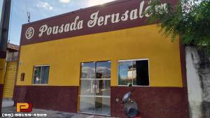a yellow building with a sign on it at Pousada Jerusalém in Carolina