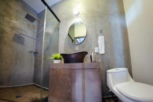 uma casa de banho com um lavatório, um WC e um espelho. em Coaranda Hotel Boutique em Arandas